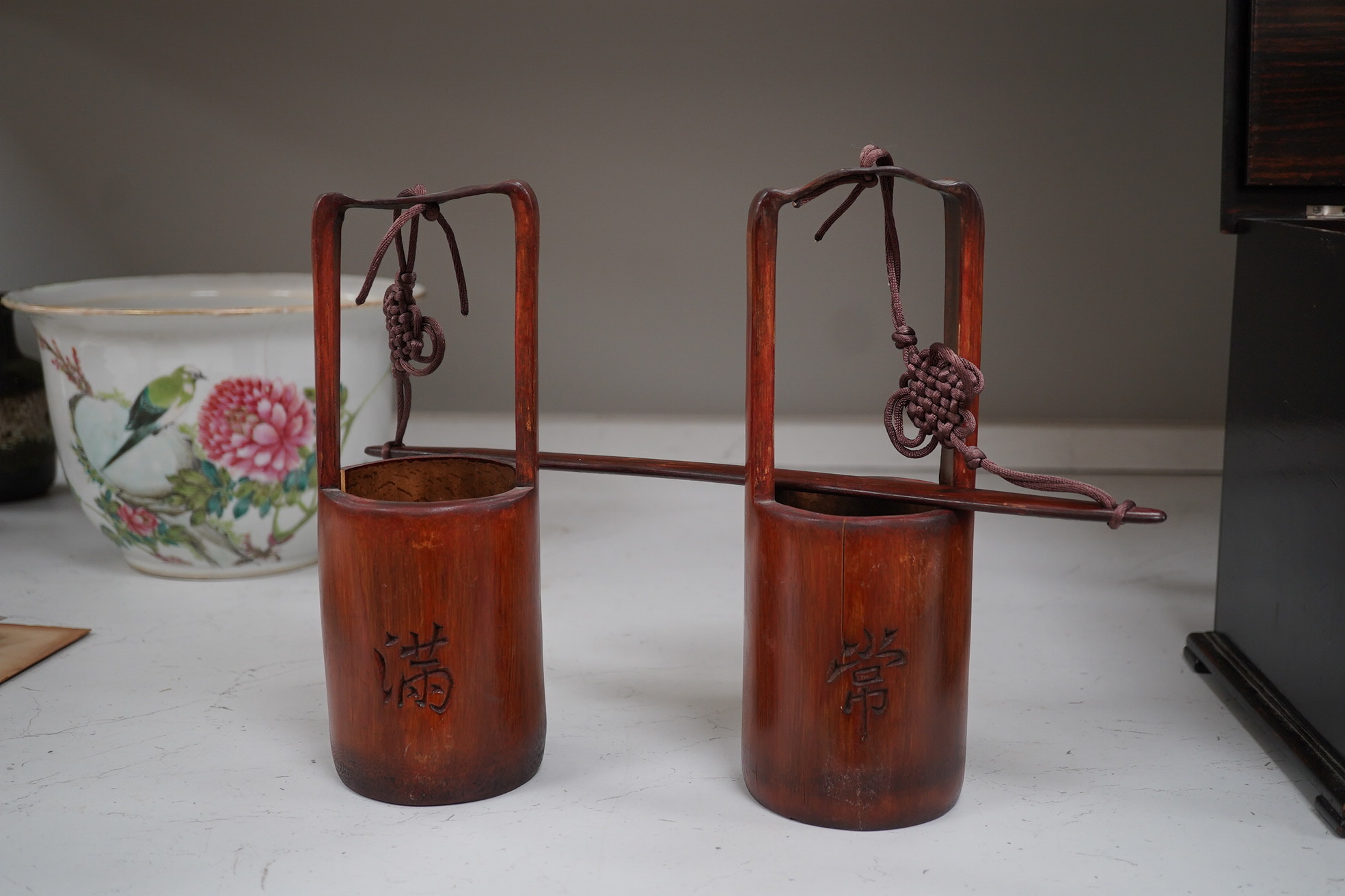 A Chinese famille rose jardiniere and bamboo oak rail, famille rose jardiniere 27cm diameter. Condition - jardiniere cracked from rim and restored, bamboo side cracked